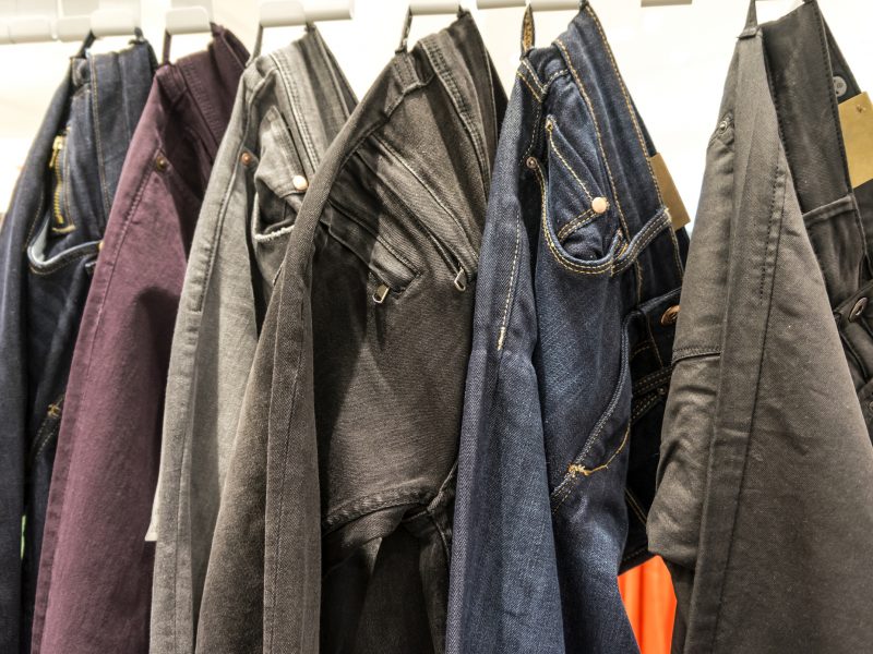 Various colors of skinny jeans hung on a rack